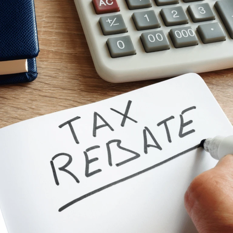 Calculator and a note reading Tax Rebate